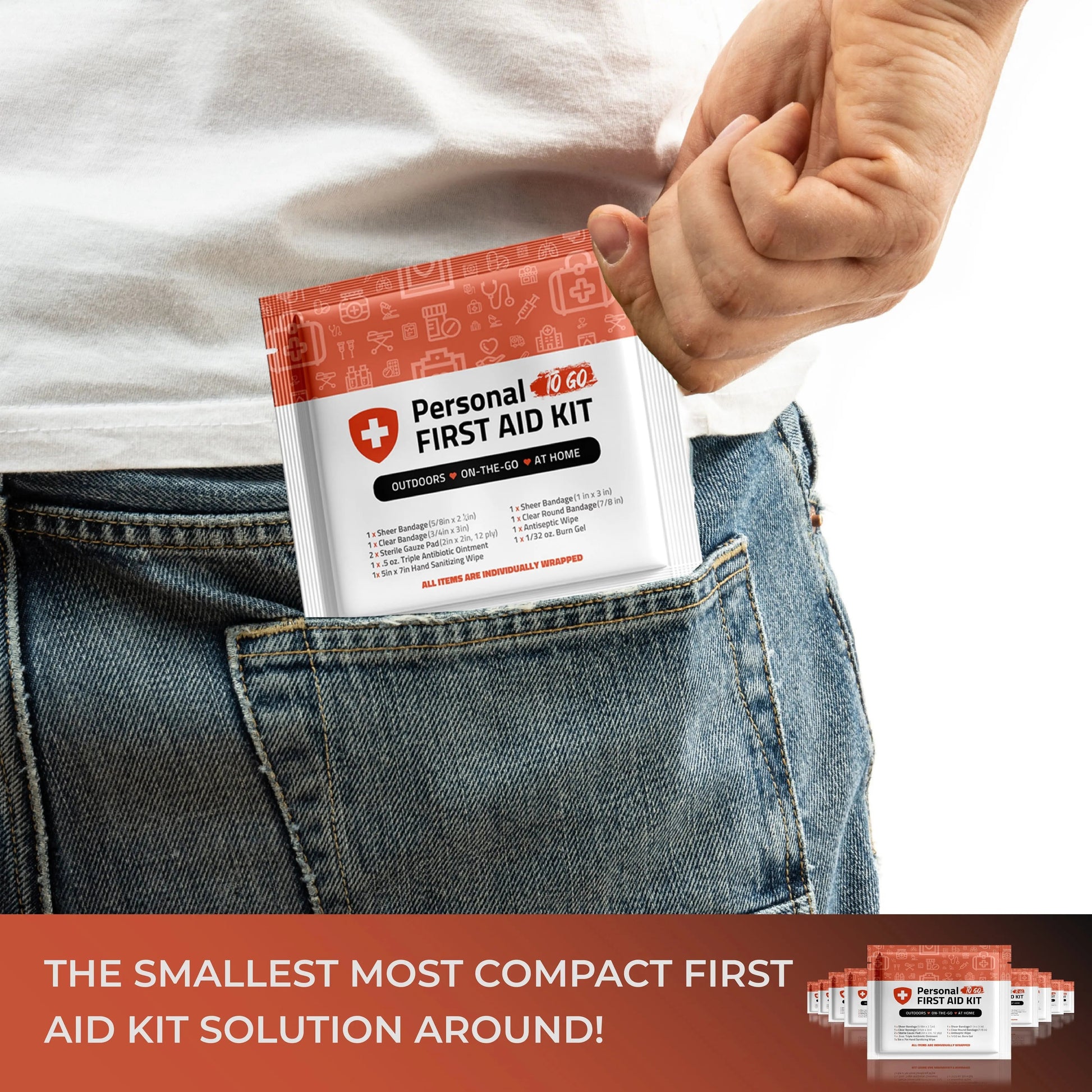 Person placing the Orange Mini First Aid Kit in a pocket—small, lightweight, and ideal for travel or daily carry.